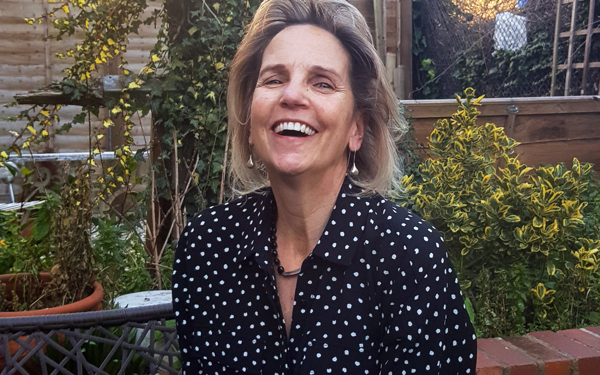 Delia Lloyd, American writer and over 50's blogger, laughing in her garden in London