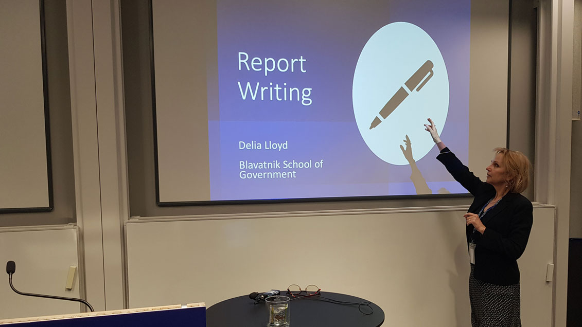 Delia Lloyd pointing to a presentation