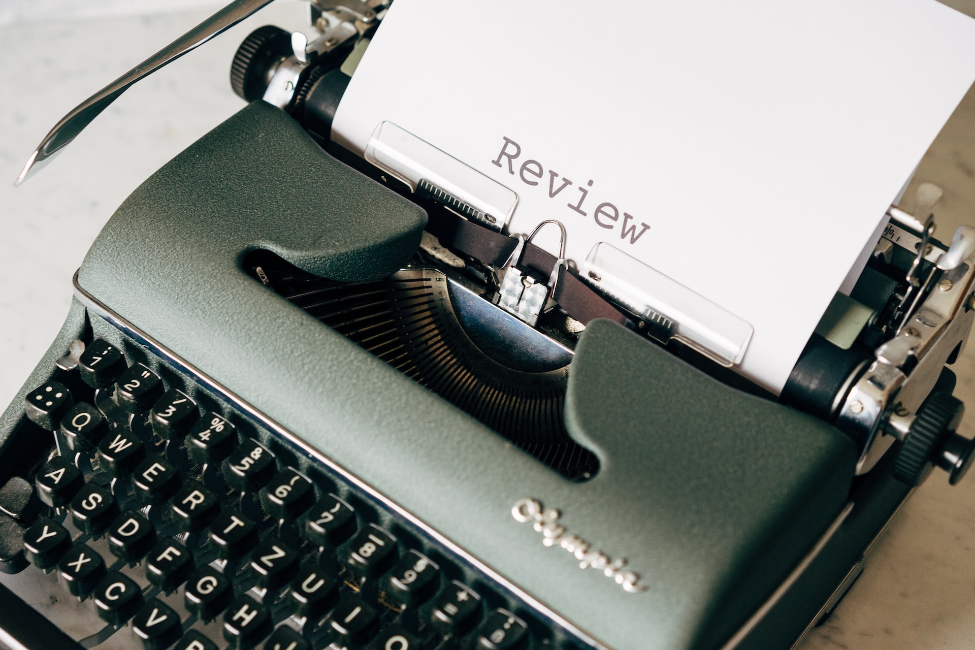 Past Year Review. Image of a typewriter with the word "review" written on a piece of paper